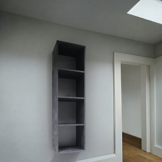 Grey box 4 shelves wall mounted on a green wall with wooden floors and a skylight.