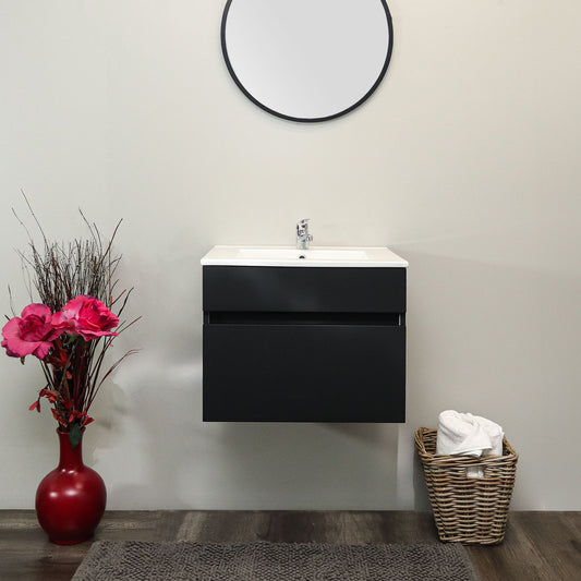 Bathroom setup with a black wall-mounted vanity, round mirror, and decorative elements.