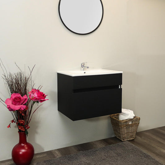 Bathroom setup with a black vanity unit, round mirror, and decorative elements.