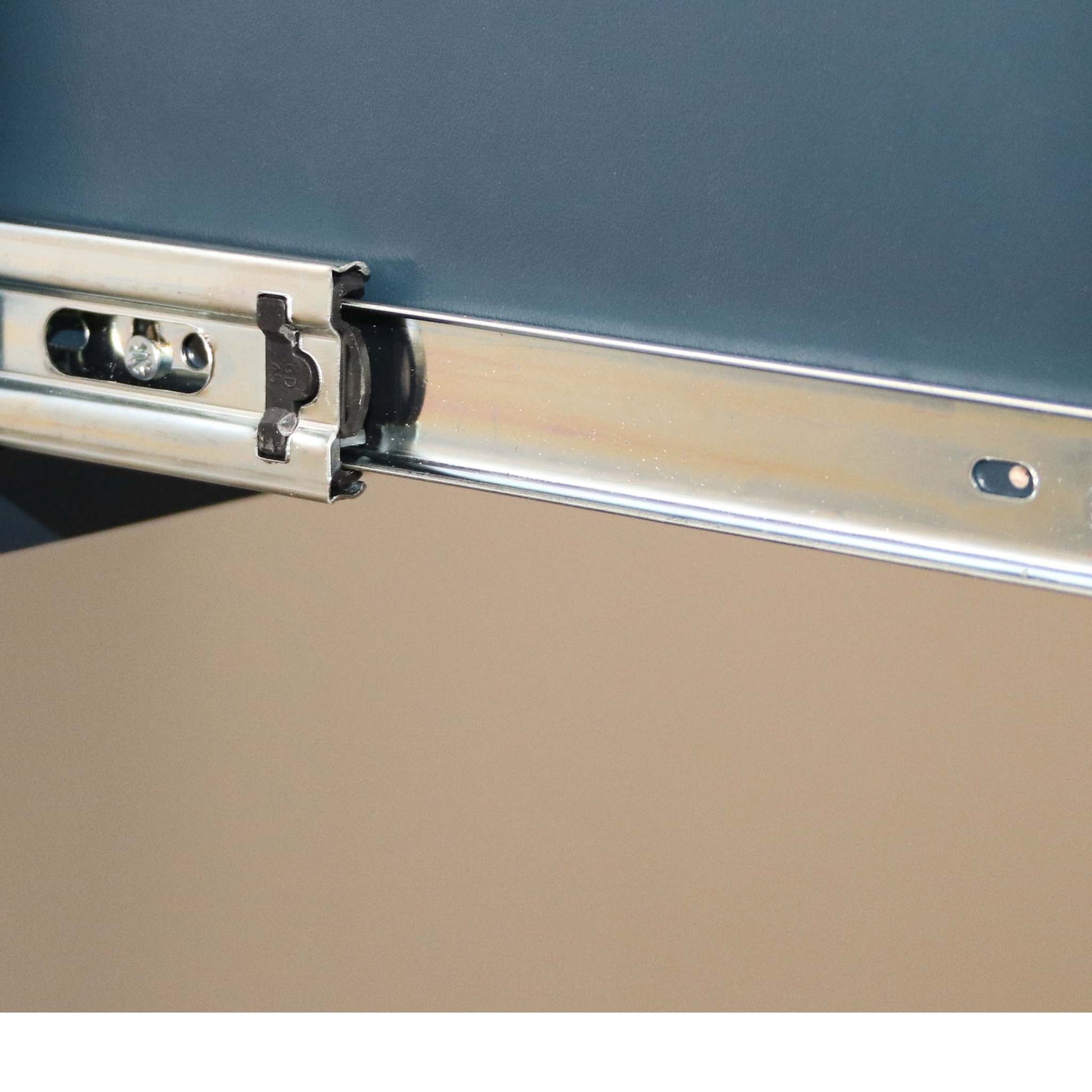 Metallic drawer slide mechanism on a cabinet door